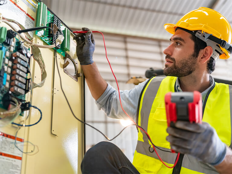 engineer testing industrial circuit breaker with diagnostic equipment