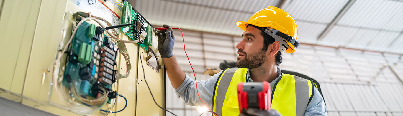 engineer testing industrial circuit breaker with diagnostic equipment